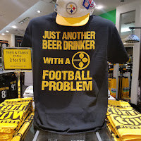 Graphic tee on display with a 2 for $18 tee deal sign