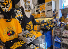 Display of gold and black fan gear, hats and accessories